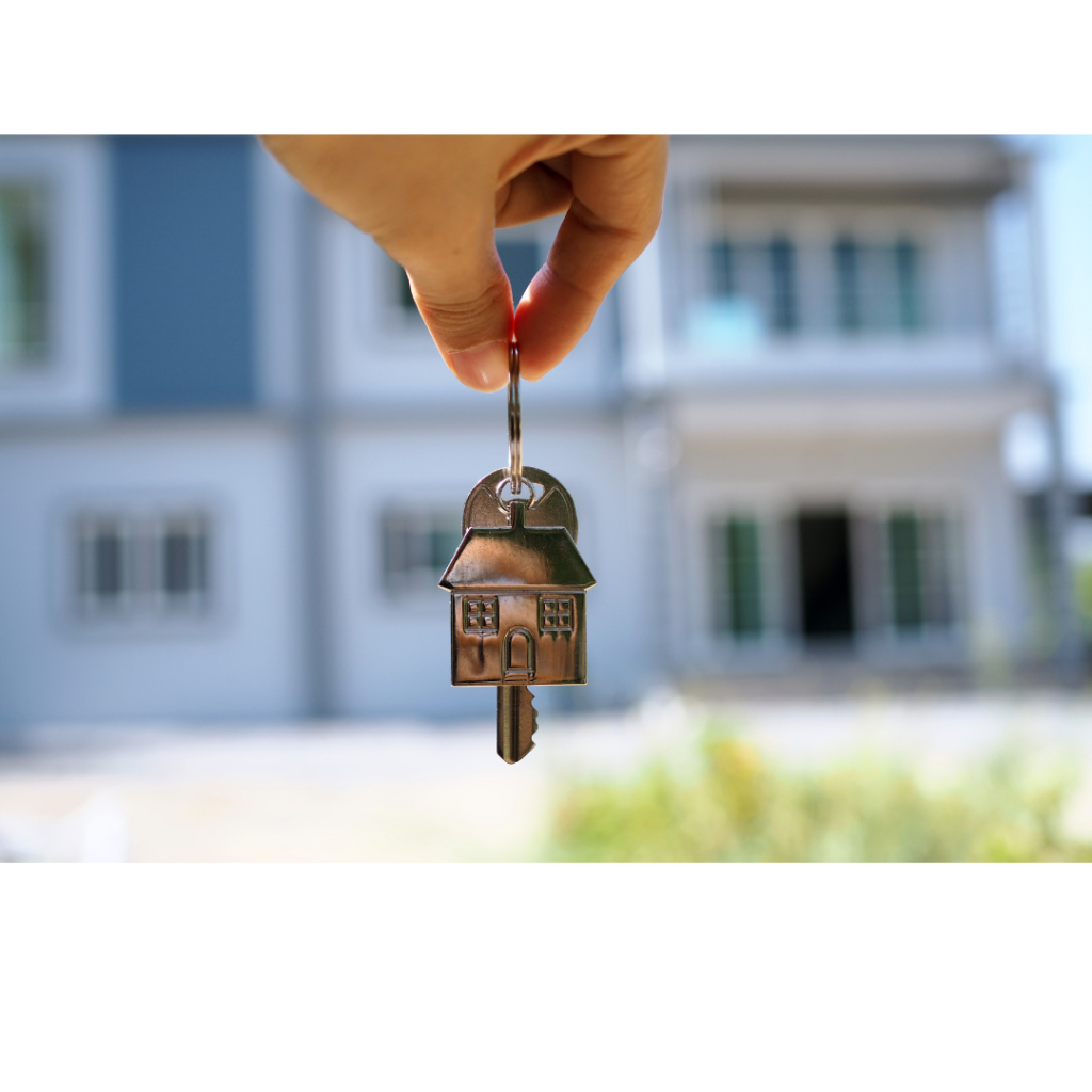 Person holds up keys to their new home