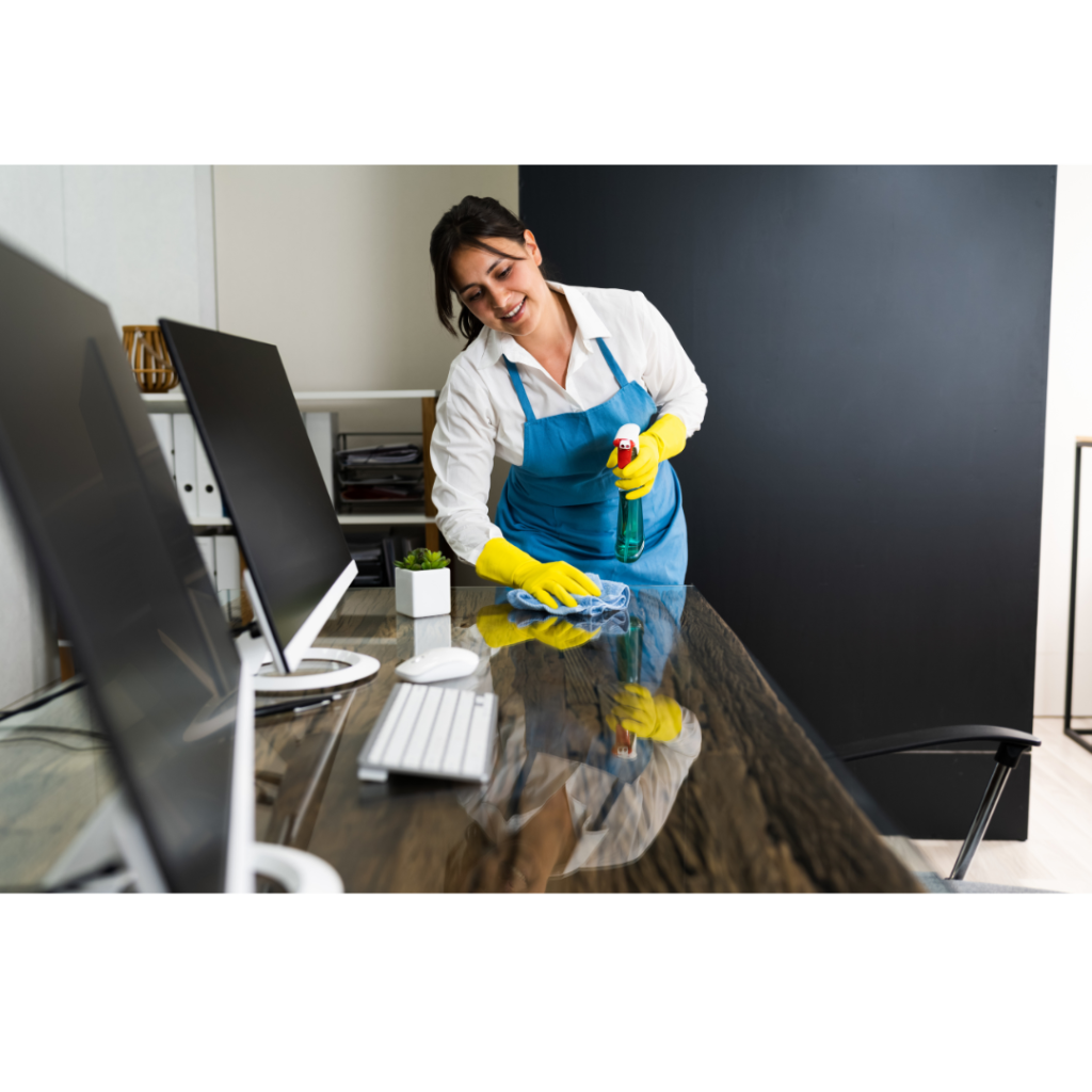 Maid cleans an office desk