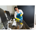 Maid cleans an office desk