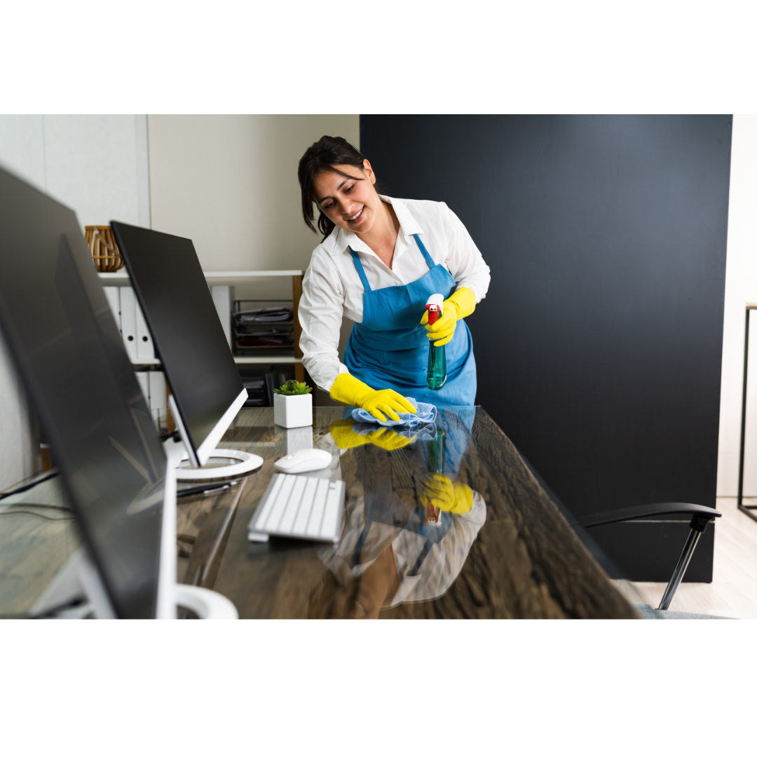 Maid cleans an office desk